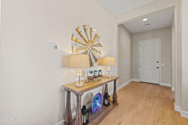 corridor with light hardwood / wood-style flooring