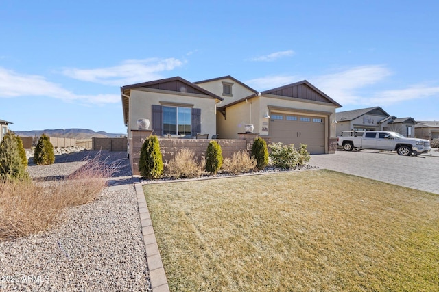 view of front of property featuring a garage and a front yard