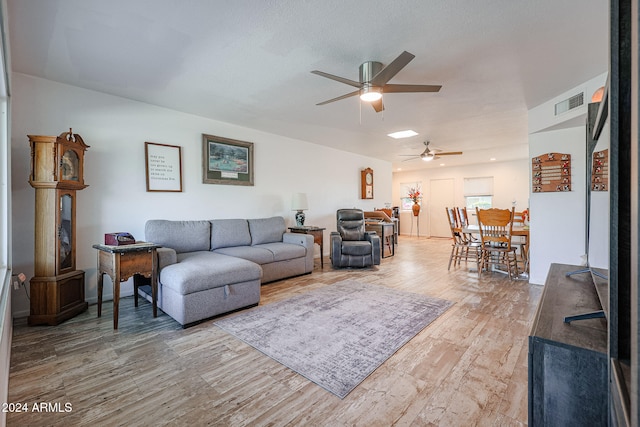 living room featuring ceiling fan and wood-type flooring