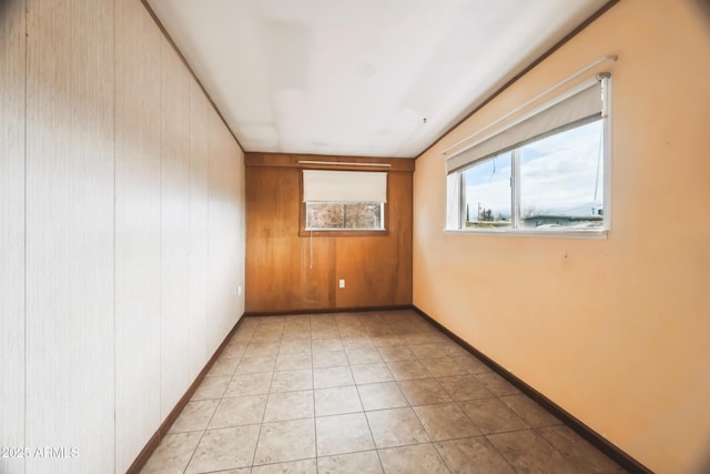 spare room featuring wood walls