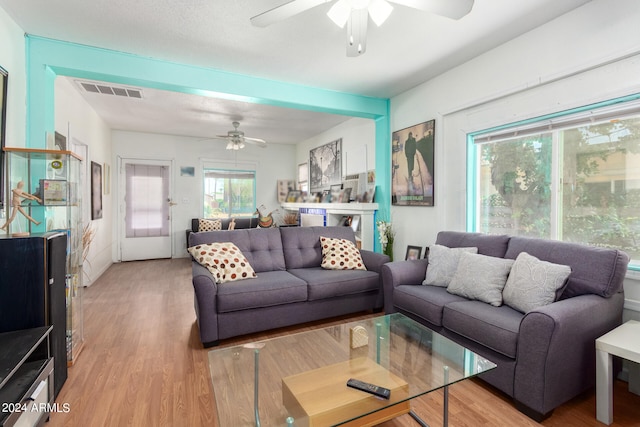 living room featuring ceiling fan and hardwood / wood-style floors