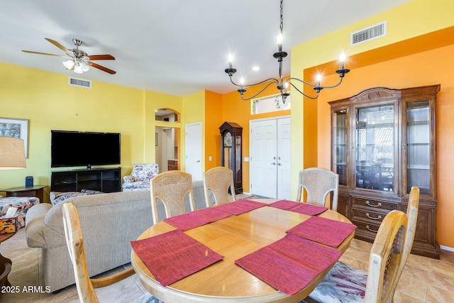 dining area featuring visible vents and ceiling fan with notable chandelier