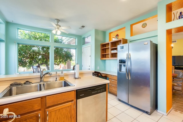 kitchen featuring light tile patterned flooring, stainless steel appliances, a sink, visible vents, and open shelves