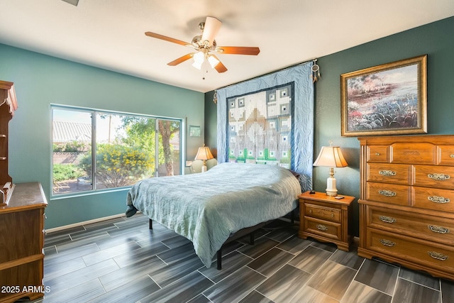 bedroom with ceiling fan and wood tiled floor