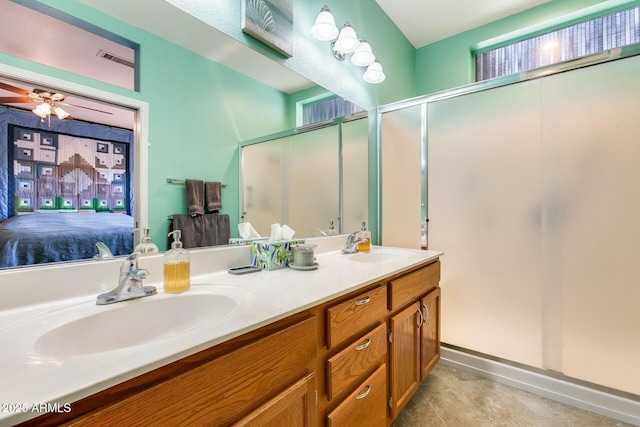 ensuite bathroom with connected bathroom, a shower with door, a sink, and double vanity