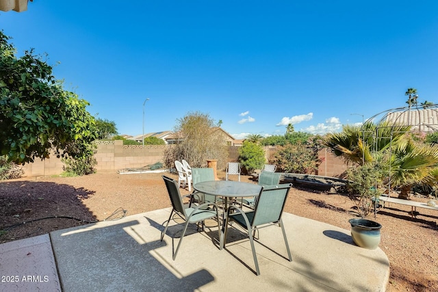 view of patio with a fenced backyard and outdoor dining space