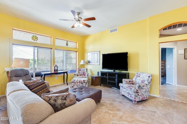 living room featuring visible vents, ceiling fan, and baseboards