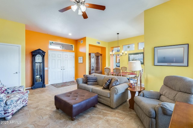 living area with visible vents, baseboards, and ceiling fan with notable chandelier