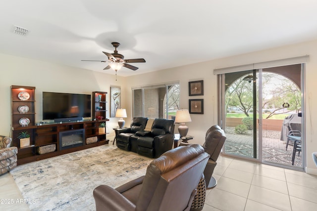 tiled living area featuring visible vents and ceiling fan