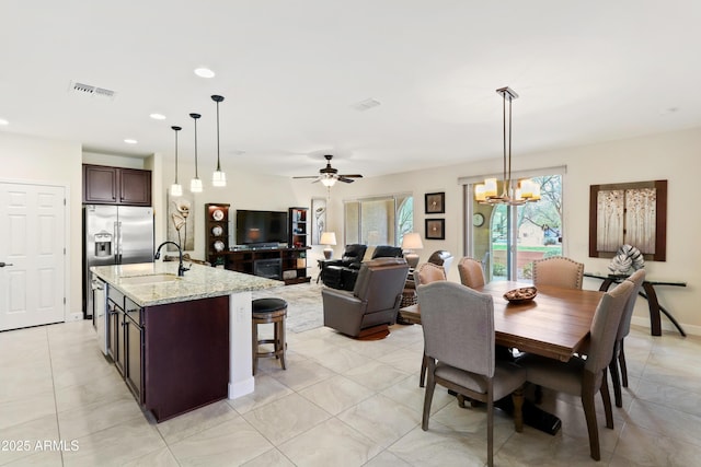 dining space featuring visible vents, baseboards, recessed lighting, ceiling fan with notable chandelier, and light tile patterned flooring