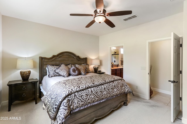 bedroom with visible vents, baseboards, light colored carpet, ensuite bathroom, and a ceiling fan