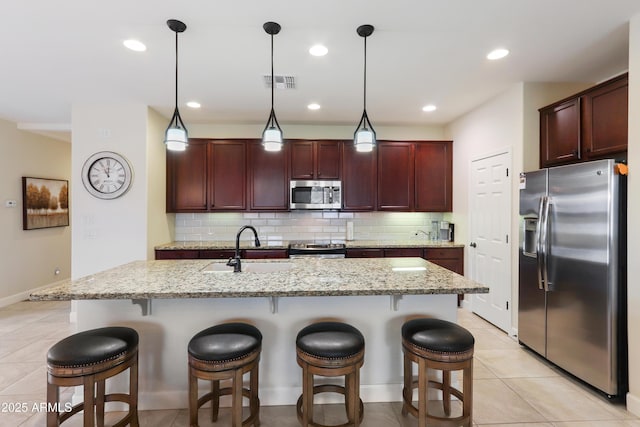 kitchen featuring a sink, visible vents, tasteful backsplash, and appliances with stainless steel finishes