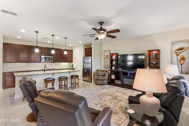 living room with recessed lighting, visible vents, light tile patterned flooring, and a ceiling fan