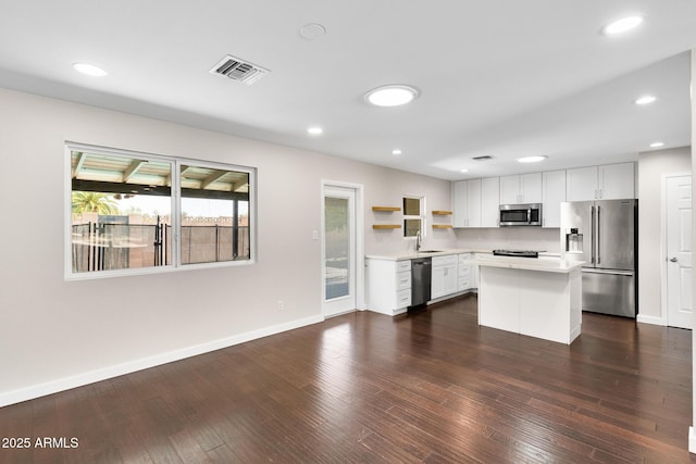 1911 E Lawrence Rd, Phoenix, AZ 85016 - kitchen with stainless steel appliances, open shelves, light countertops, a center island, and white cabinetry