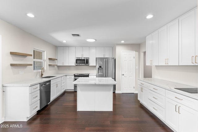 1911 E Lawrence Rd, Phoenix, AZ 85016 - kitchen with stainless steel appliances, open shelves, a center island, light stone counters, and dark wood finished floors