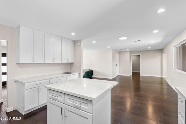 1911 E Lawrence Rd, Phoenix, AZ 85016 - kitchen featuring dark wood-style floors, white cabinetry, recessed lighting, open floor plan, and light stone counters