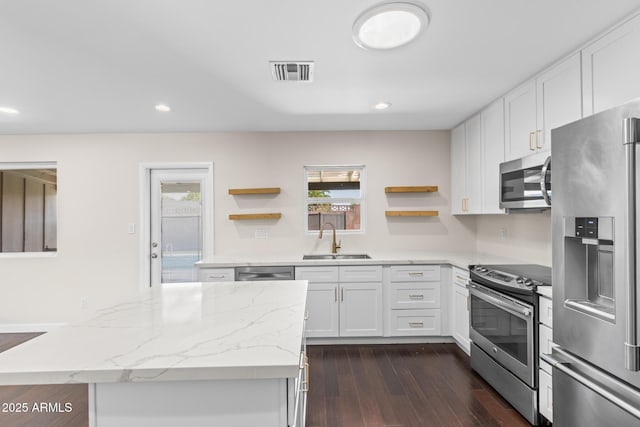 1911 E Lawrence Rd, Phoenix, AZ 85016 - kitchen featuring stainless steel appliances, open shelves, dark wood finished floors, white cabinetry, and recessed lighting