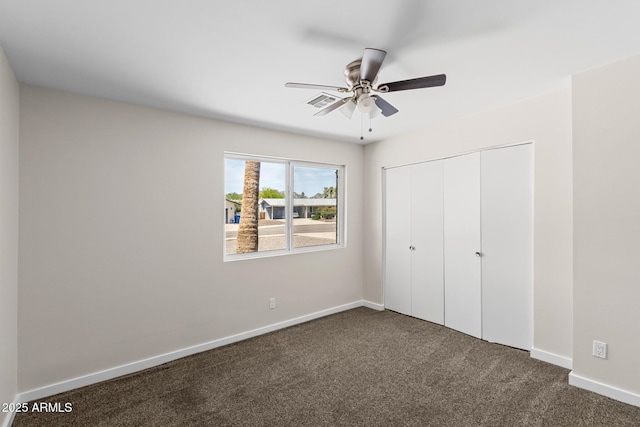 1911 E Lawrence Rd, Phoenix, AZ 85016 - unfurnished bedroom featuring dark colored carpet, a closet, and ceiling fan