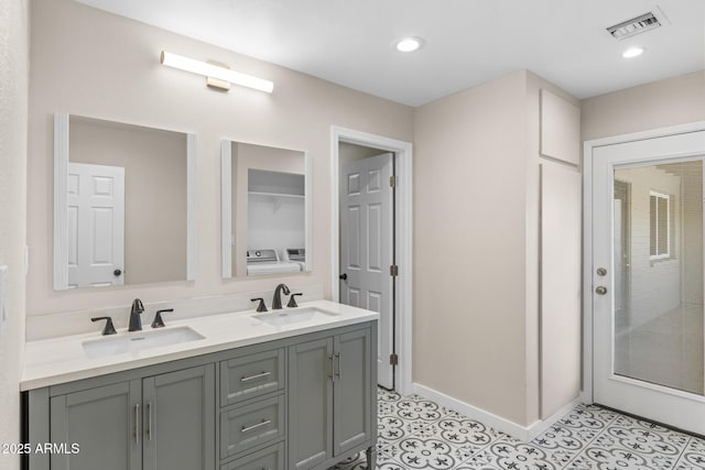 1911 E Lawrence Rd, Phoenix, AZ 85016 - bathroom featuring double vanity, washing machine and dryer, tile patterned flooring, and recessed lighting