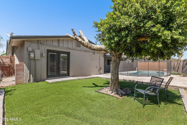 1911 E Lawrence Rd, Phoenix, AZ 85016 - back of property featuring french doors, a fenced backyard, and a patio area