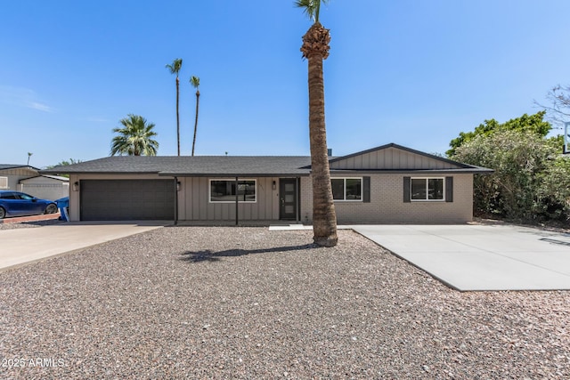 1911 E Lawrence Rd, Phoenix, AZ 85016 - ranch-style home with concrete driveway, board and batten siding, an attached garage, brick siding, and roof with shingles