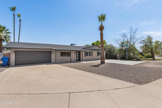 1911 E Lawrence Rd, Phoenix, AZ 85016 - ranch-style home with concrete driveway, a garage, and board and batten siding