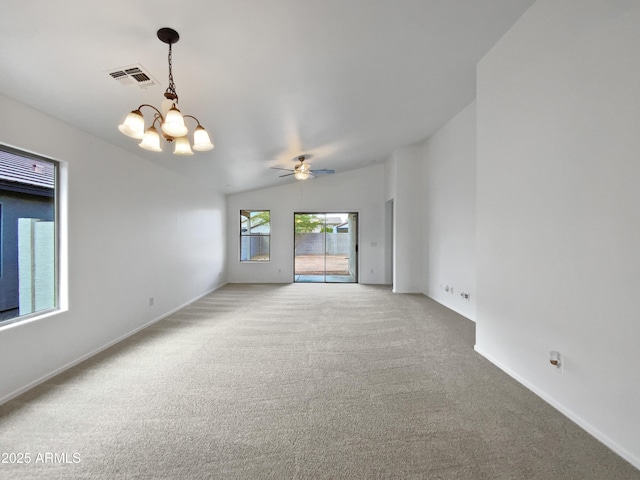 unfurnished room with carpet floors, vaulted ceiling, and ceiling fan with notable chandelier