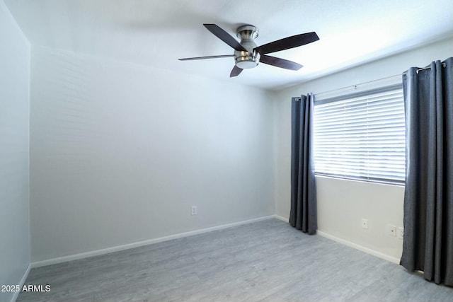 unfurnished room featuring baseboards, a ceiling fan, and light wood finished floors