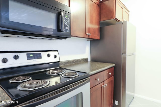 kitchen featuring dark countertops and appliances with stainless steel finishes