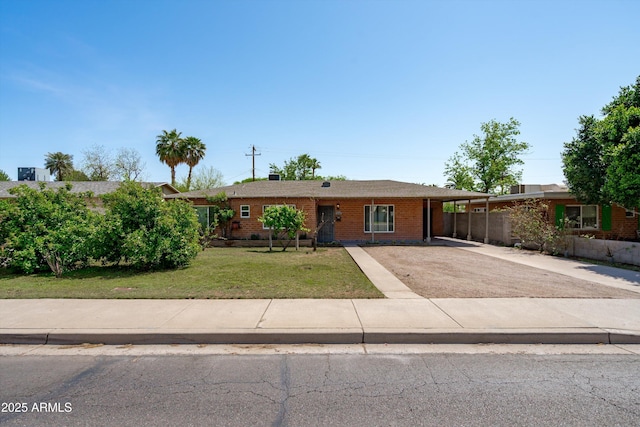 5709 N 16th St, Phoenix, AZ 85016 - ranch-style house featuring a carport, concrete driveway, a front lawn, and brick siding