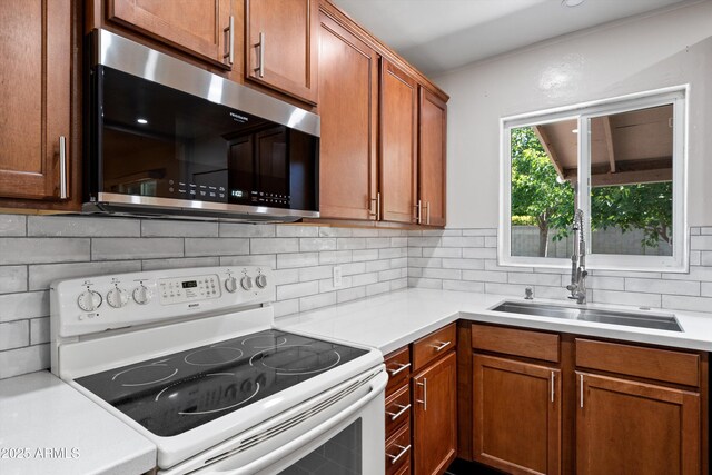 5709 N 16th St, Phoenix, AZ 85016 - kitchen with stainless steel microwave, light countertops, backsplash, electric stove, and a sink