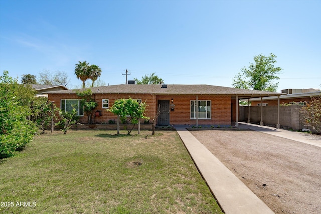 5709 N 16th St, Phoenix, AZ 85016 - ranch-style home featuring a front yard, a carport, fence, brick siding, and driveway