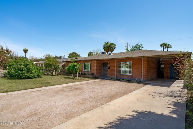 5709 N 16th St, Phoenix, AZ 85016 - ranch-style house with a carport, concrete driveway, a front lawn, and brick siding