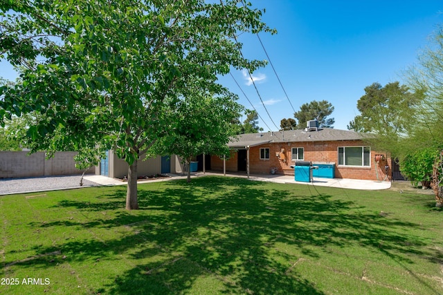 5709 N 16th St, Phoenix, AZ 85016 - back of property featuring a yard, fence, brick siding, and a patio