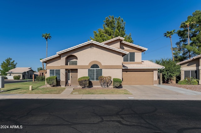 view of front of house featuring a garage and a front yard