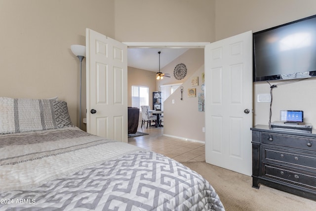 bedroom featuring vaulted ceiling and light tile patterned floors