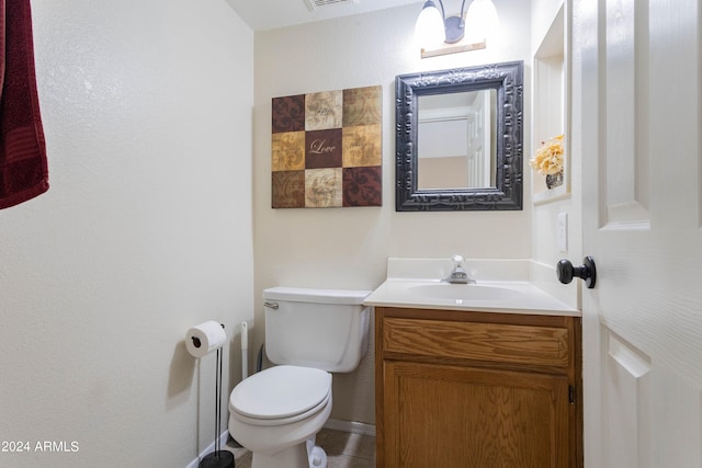 bathroom featuring toilet and vanity