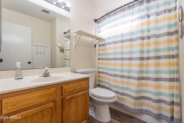 bathroom featuring vanity, toilet, a shower with curtain, and hardwood / wood-style floors