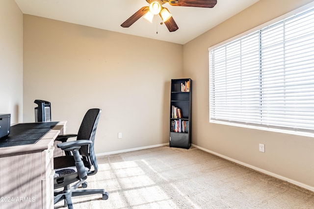 office area featuring light colored carpet, a healthy amount of sunlight, and ceiling fan