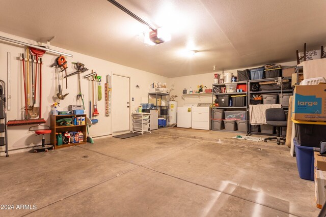 garage featuring a garage door opener, water heater, and washer and clothes dryer