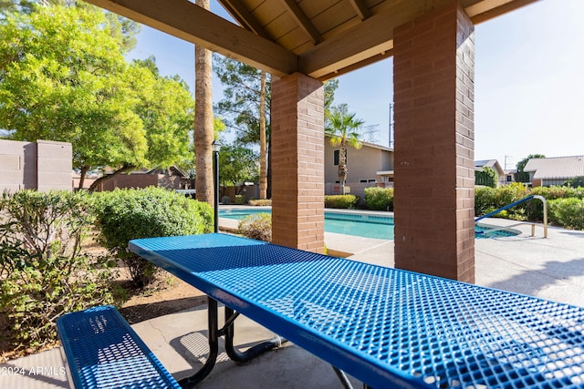 view of patio with a community pool