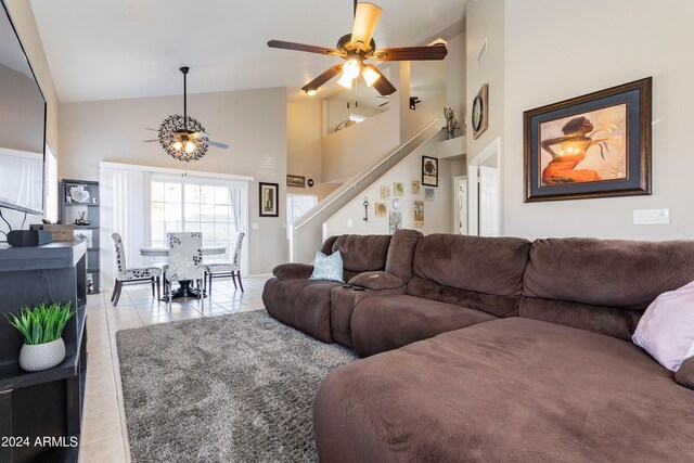 living room featuring high vaulted ceiling, ceiling fan, and light tile patterned floors