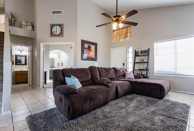 tiled living room with high vaulted ceiling and ceiling fan