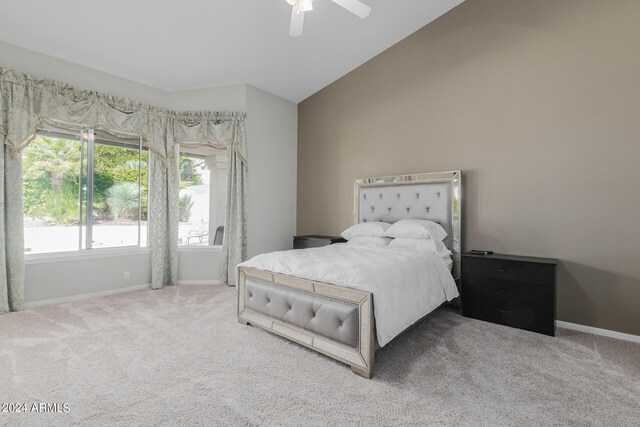 carpeted bedroom with ceiling fan and lofted ceiling