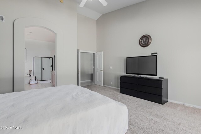 carpeted bedroom featuring ceiling fan and high vaulted ceiling