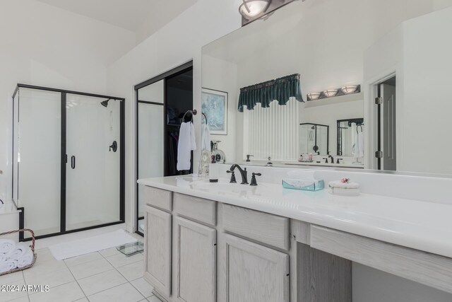 bathroom featuring vanity, tile patterned floors, and a shower with shower door