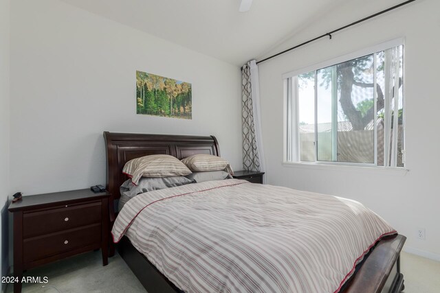 carpeted bedroom featuring ceiling fan and vaulted ceiling