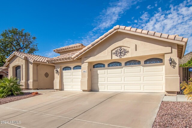 mediterranean / spanish house featuring a garage