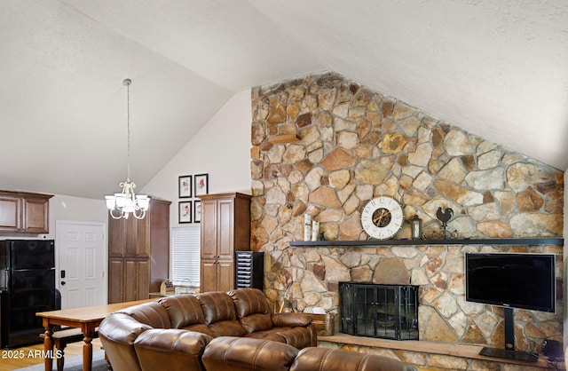 living room with a fireplace, an inviting chandelier, and vaulted ceiling