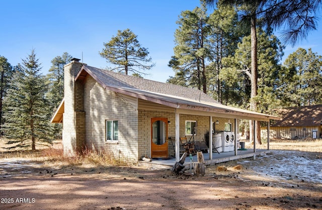 view of front of home featuring washer / clothes dryer and a porch